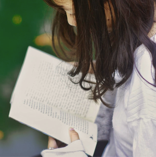 Hands holding music book