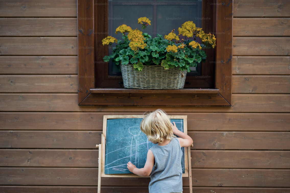 Child drawing on blackboard