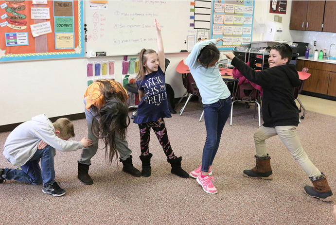 Children in a line participating in an activity