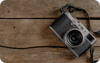 A camera sits on a wooden floor