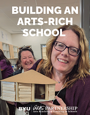 Cover of a book. The cover features a woman holding up an art project that she did while she and other people in the picture are smiling.