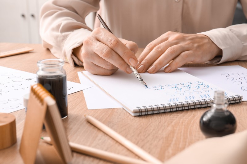 Someone drawing on a piece of paper